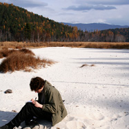 Alex writing on the beach